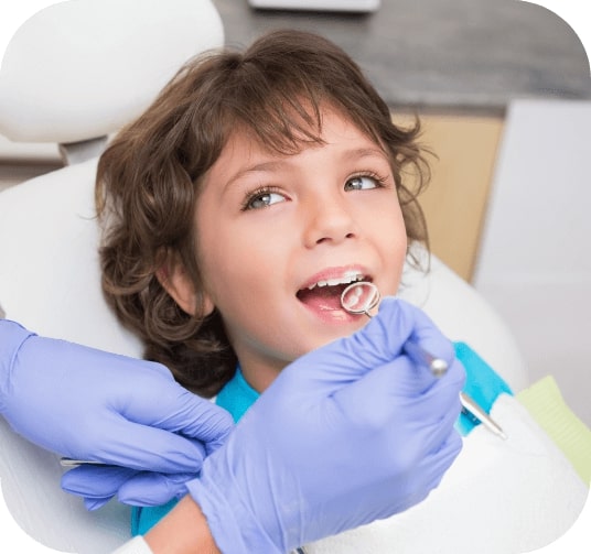 Child receiving dental checkup and teeth cleaning