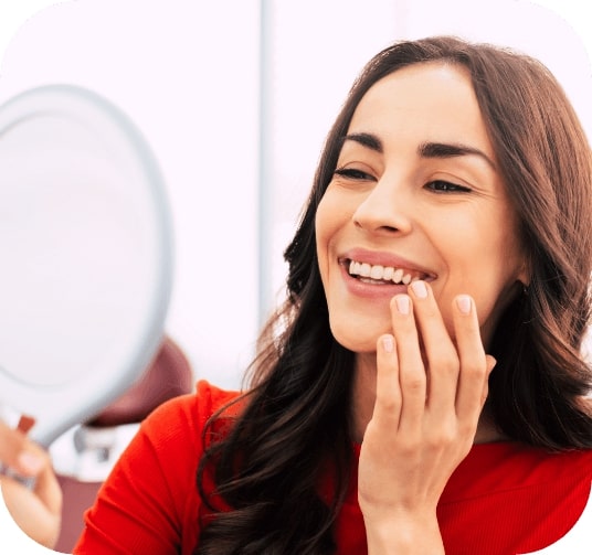 Woman smiling after discussing the cost of dental implants