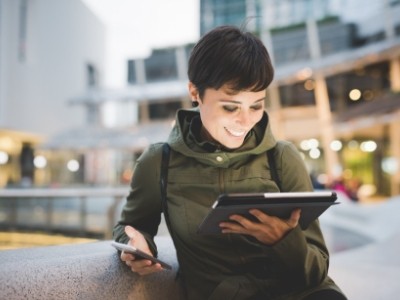 Woman downloading forms on tablet computer