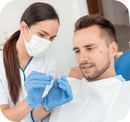 Dentist and dental patient discussing how Invisalign works