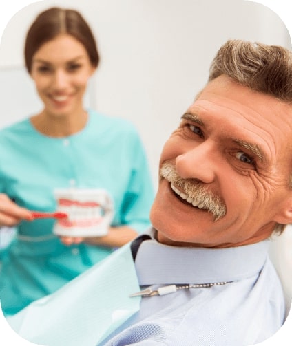 Man smiling after replacing missing teeth